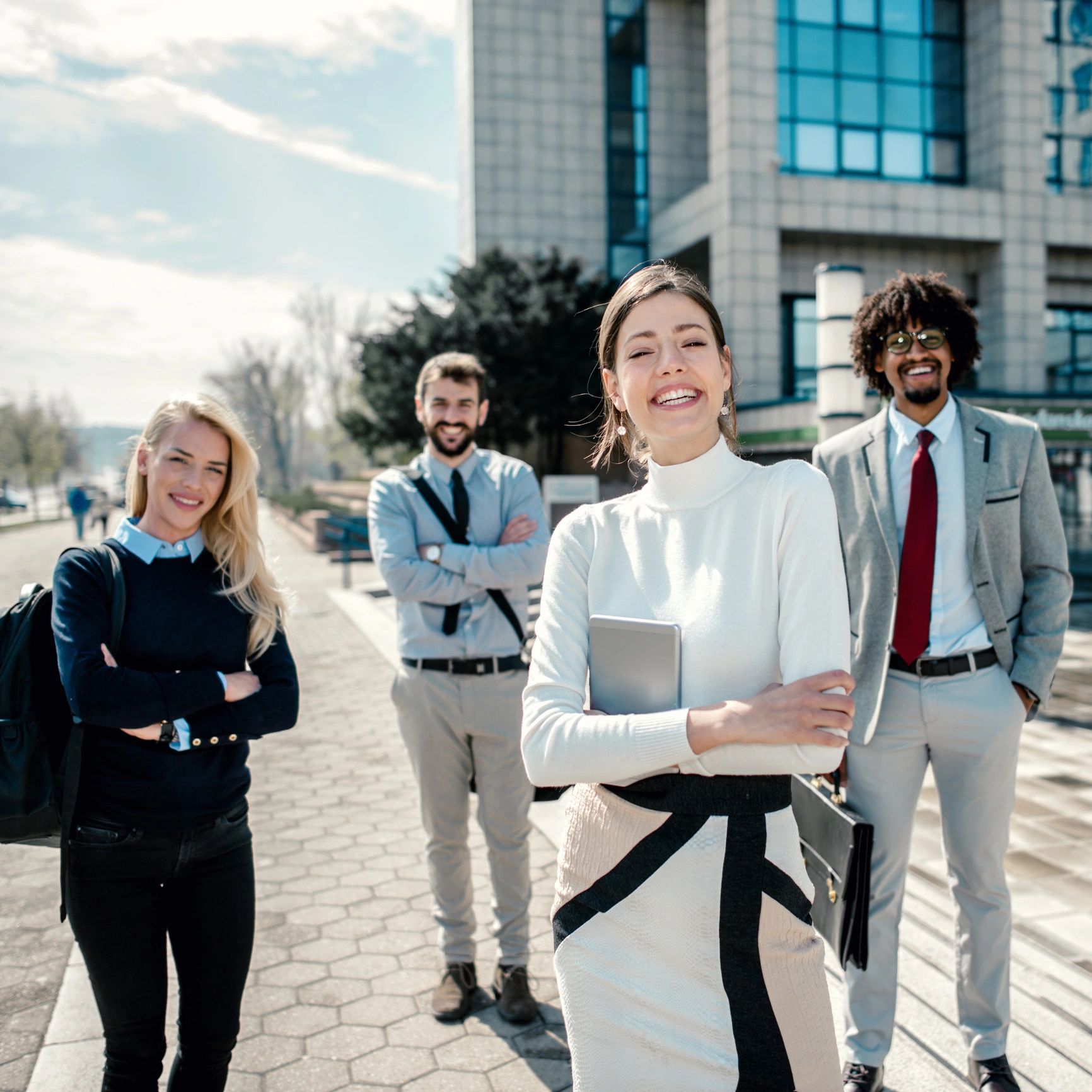 Professional team standing outside an office building