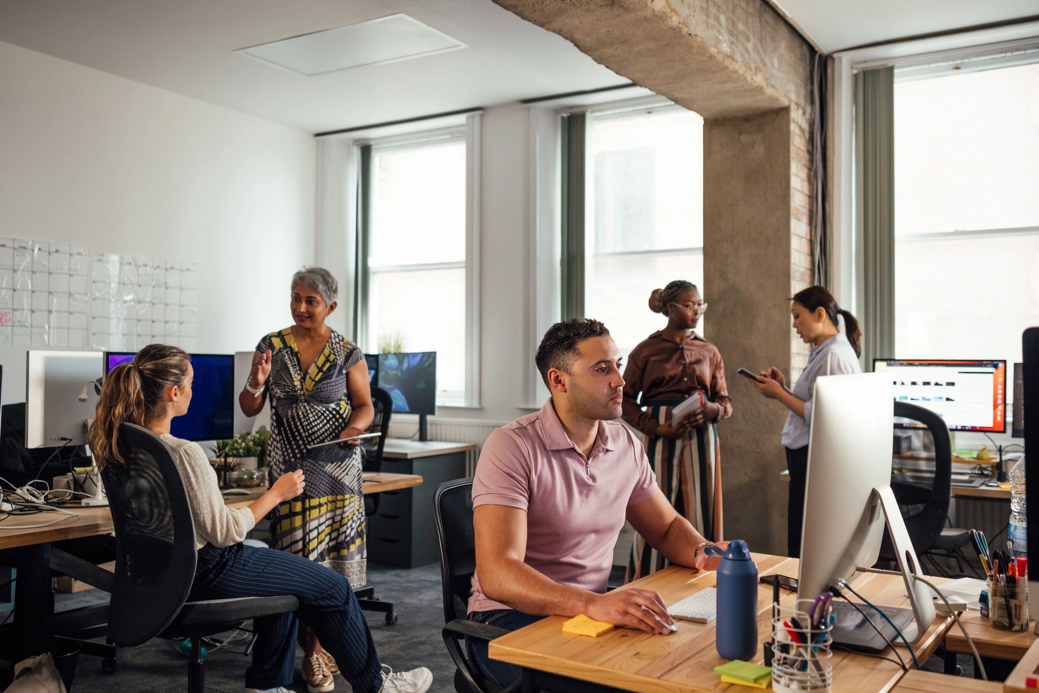 Clyros.AI team collaborating in a modern office